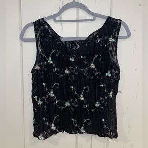 Black sheer crop top full of little white embroidered flowers.